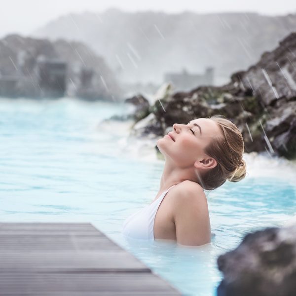 Woman,Enjoying,Natural,Spa,,Blue,Lagoon,Is,A,Geothermal,Spa Woman enjoying natural spa, Blue Lagoon is a geothermal spa in southwestern Iceland, is located in a lava field near Grindavk on the Reykjanes Peninsula